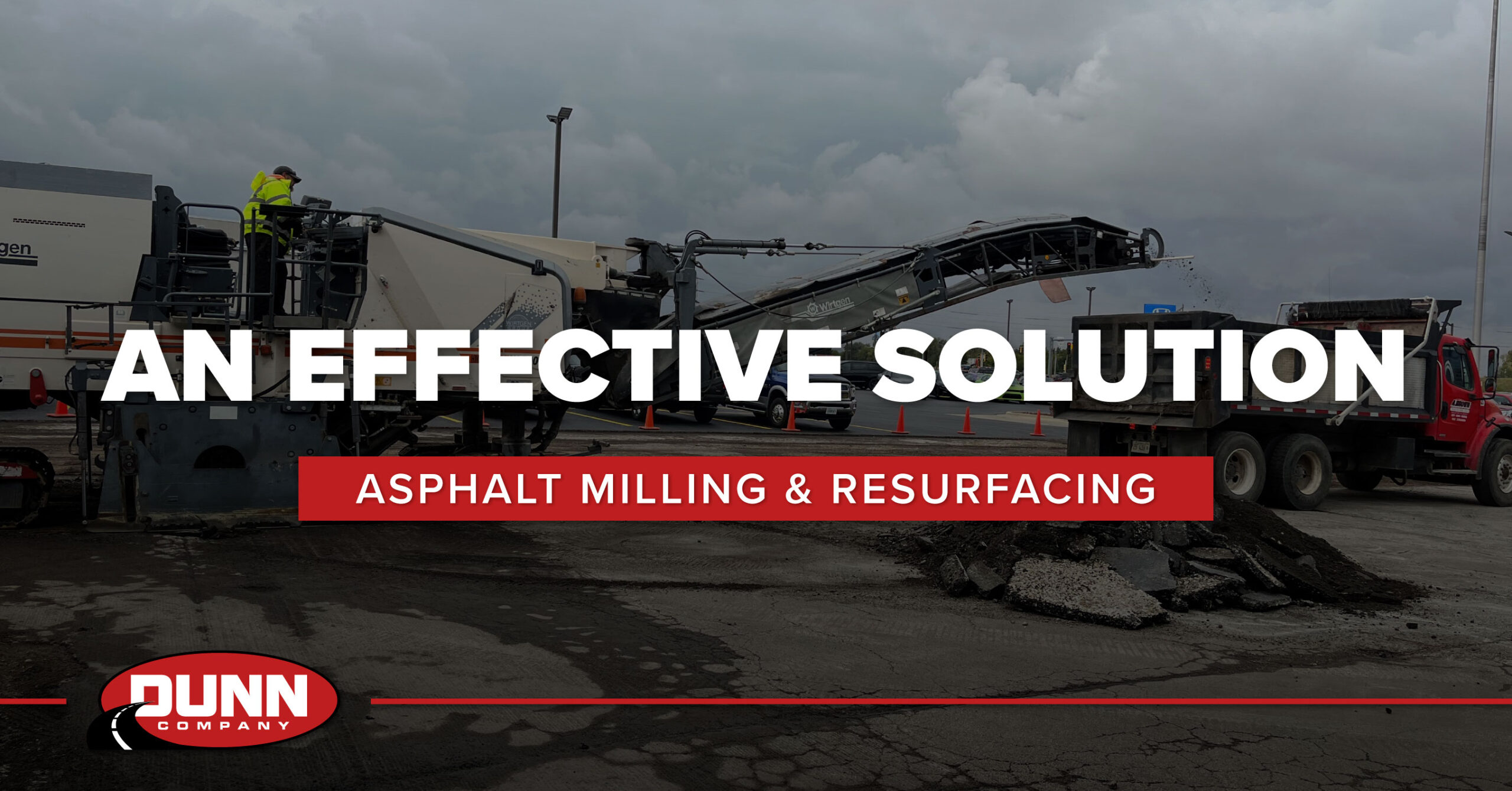 Asphalt milling machine removing old pavement as part of road resurfacing project
