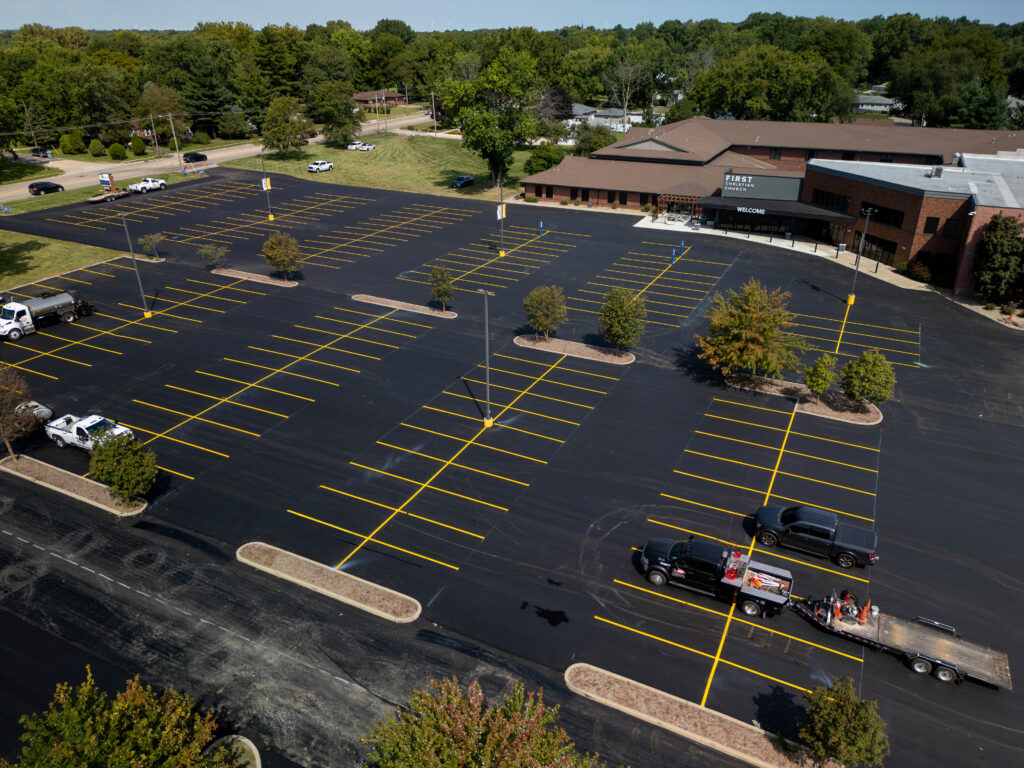 Fresh parking lot striping on newly paved church parking lot aerial view